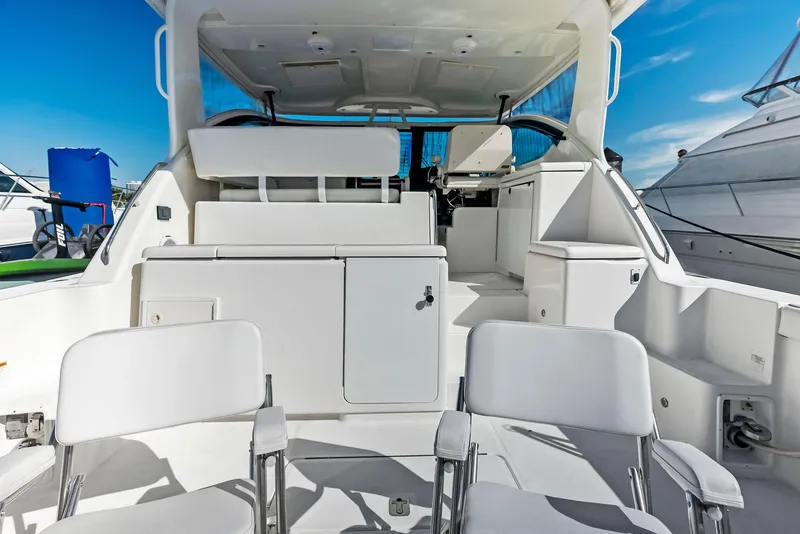 Slide: The Image of 2004 Tiara Yachts 4200 Open interior with white seating and cabinetry. - 21
