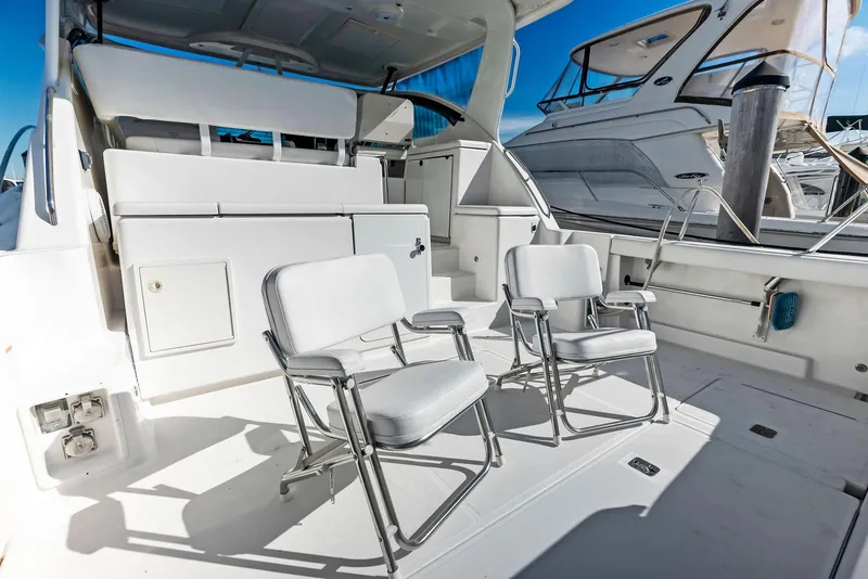 Slide: The Image of 2004 Tiara Yachts 4200 Open deck with chairs, showcasing luxury and comfort. - 22