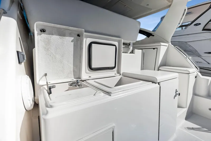 Slide: The Image of 2004 Tiara Yachts 4200 Open interior with storage compartments and sleek design. - 24