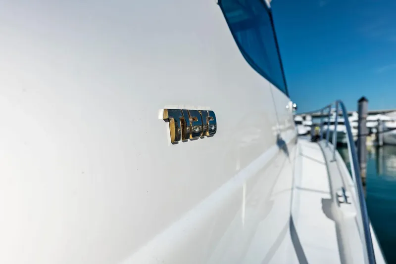 Slide: The Image of 2004 Tiara Yachts 4200 Open, side view with logo, docked in marina. - 25