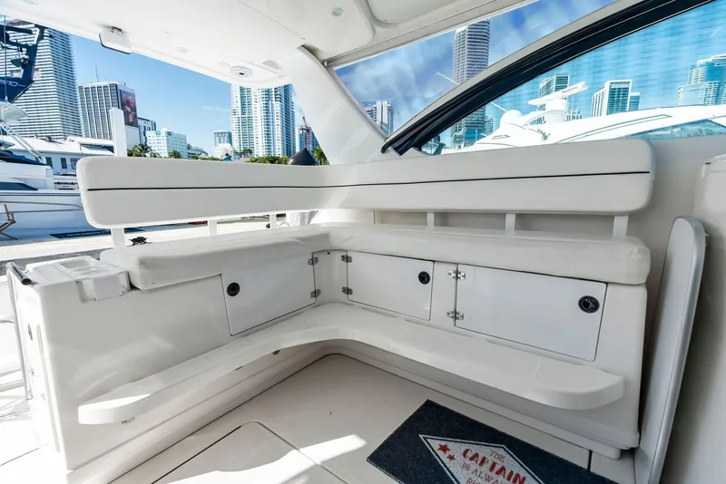 Slide: The Image of 2004 Tiara Yachts 4200 Open interior with white seating and city skyline view. - 28