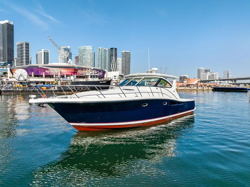 Slide: The Image of 2004 Tiara Yachts 4200 Open in urban marina, city skyline background. - 3