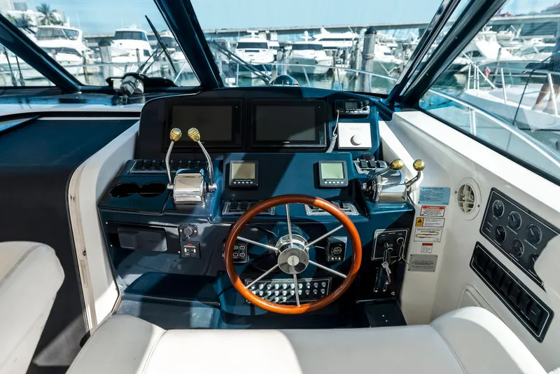 Slide: The Image of 2004 Tiara Yachts 4200 Open helm with modern controls and navigation displays. - 31