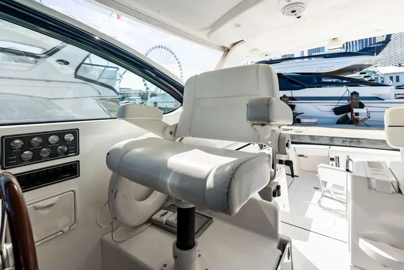 Slide: The Image of 2004 Tiara Yachts 4200 Open helm seat with marina view. - 32