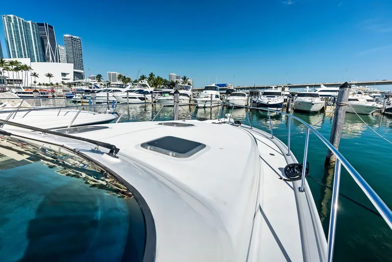 Slide: The Image of Tiara Yachts 4200 Open 2004 docked in a marina with city skyline. - 33