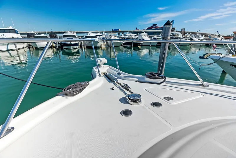 Slide: The Image of 2004 Tiara Yachts 4200 Open at marina, clear blue sky, calm waters. - 34