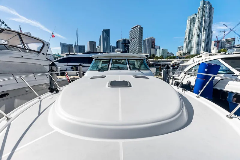 Slide: The Image of 2004 Tiara Yachts 4200 Open docked with city skyline in background. - 35