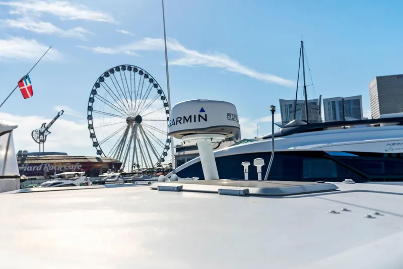 Slide: The Image of 2004 Tiara Yachts 4200 Open with cityscape and Ferris wheel in background. - 36