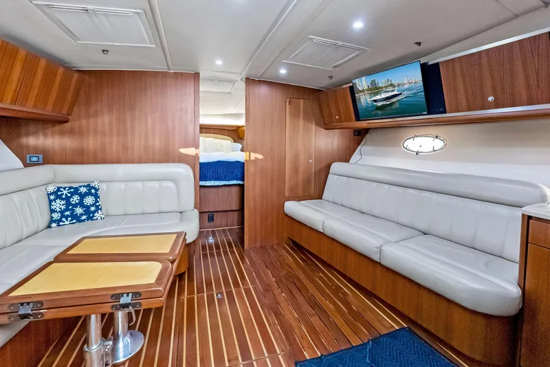 Slide: The Image of Luxurious interior of 2004 Tiara Yachts 4200 Open with elegant wood finish and plush seating. - 37