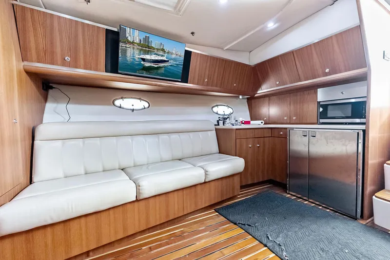 Slide: The Image of Interior of 2004 Tiara Yachts 4200 Open with modern kitchen and seating area. - 39
