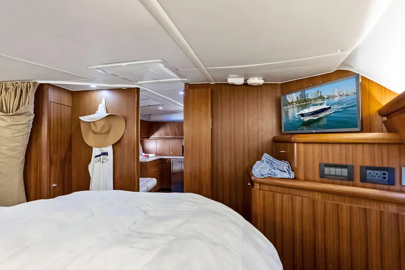Slide: The Image of Luxurious 2004 Tiara Yachts 4200 Open cabin interior with wood paneling and cozy bedding. - 42