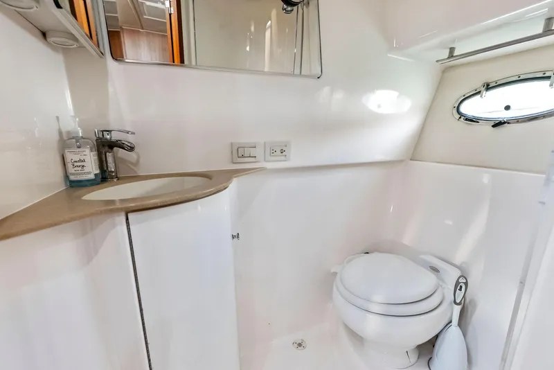 Slide: The Image of 2004 Tiara Yachts 4200 Open bathroom with modern fixtures and porthole window. - 43