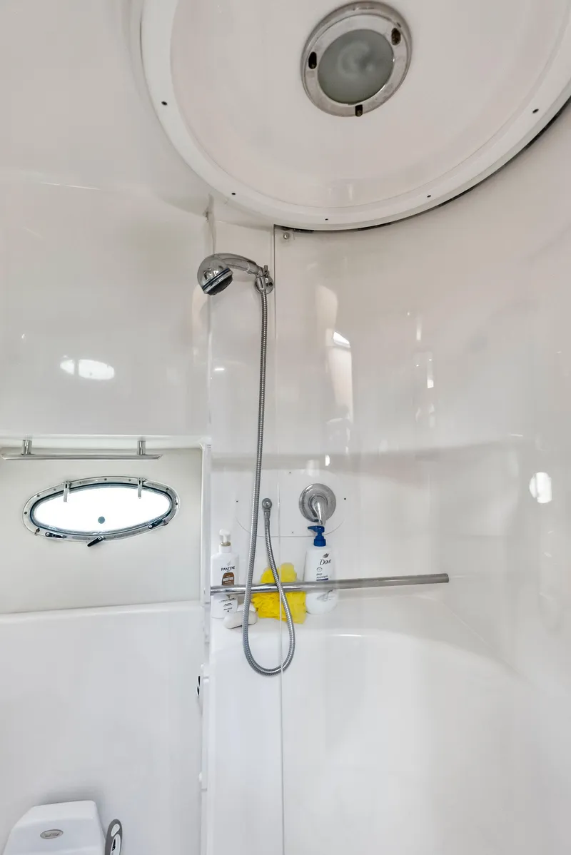 Slide: The Image of 2004 Tiara Yachts 4200 Open bathroom with shower and porthole window. - 44