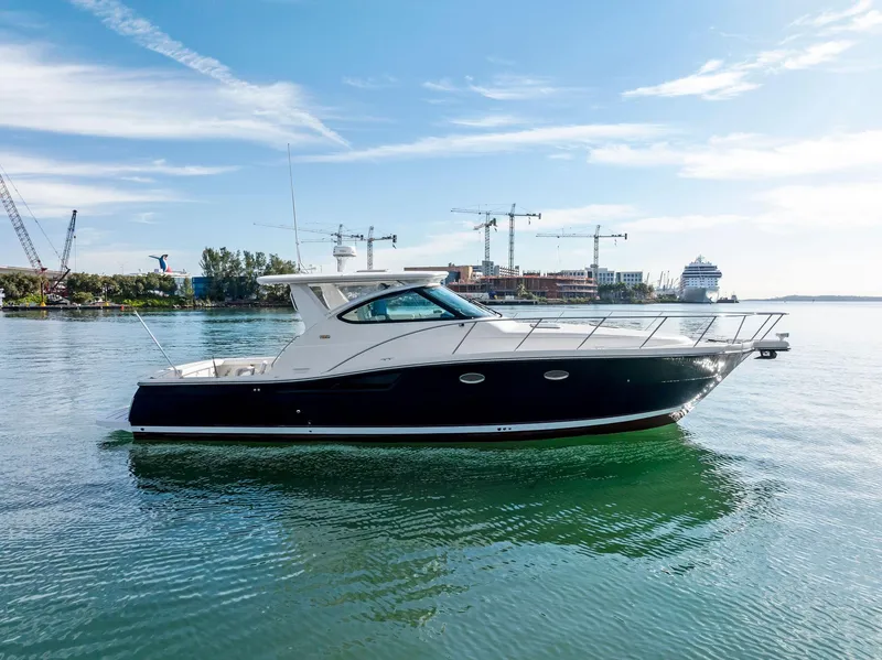 Slide: The Image of 2004 Tiara Yachts 4200 Open cruising on calm waters, cityscape in background. - 6