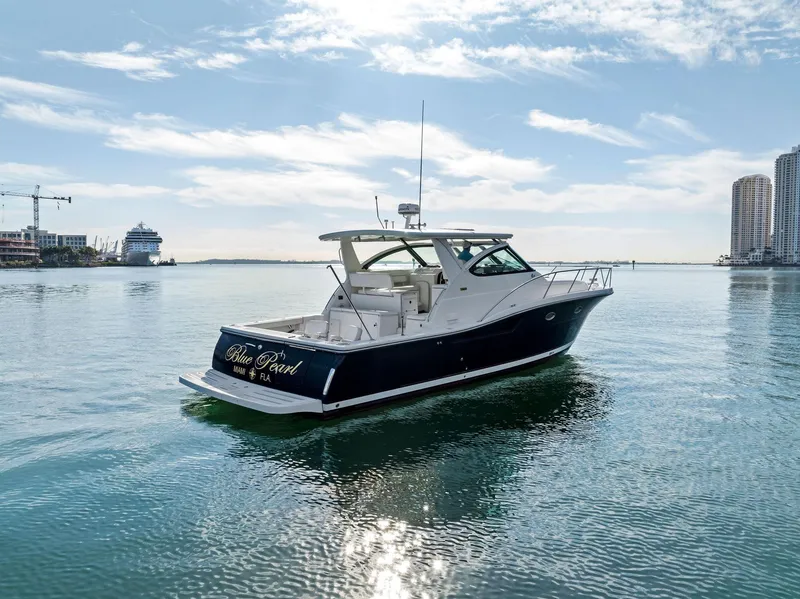 Slide: The Image of 2004 Tiara Yachts 4200 Open cruising in a serene harbor setting. - 7