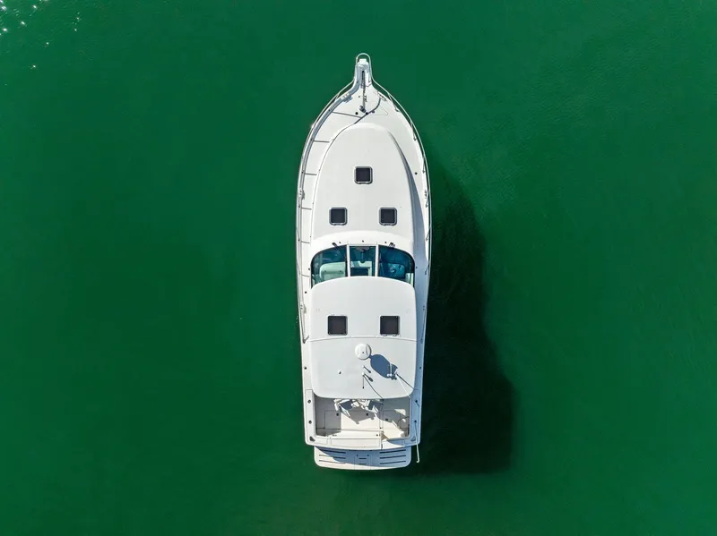 Slide: The Image of Aerial view of 2004 Tiara Yachts 4200 Open on green water. - 9