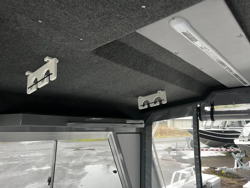 Slide: The Image of 2024 Thunder Jet 20 Chinook Pro interior ceiling with mounted rod holders. - 10