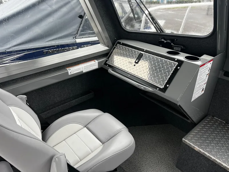 Slide: The Image of 2024 Thunder Jet 20 Chinook Pro interior with seating and storage compartment. - 7