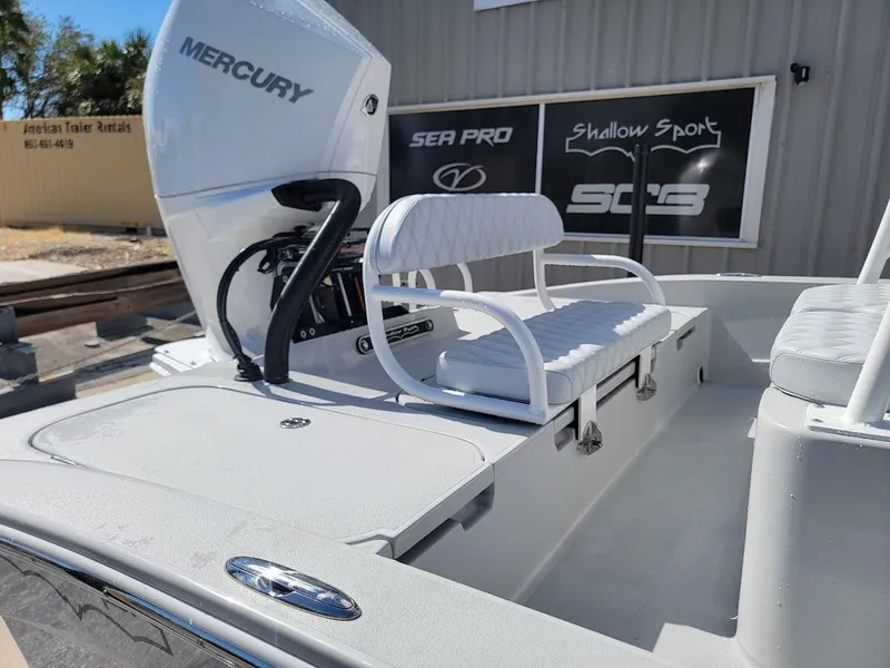 Slide: The Image of 2025 Shallow Sport 24 Modified V boat with Mercury engine, white seating, and storage compartments. - 11