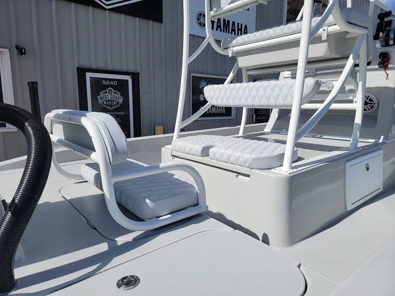 Slide: The Image of 2025 Shallow Sport 24 Modified V boat interior with cushioned seating and steps. - 12