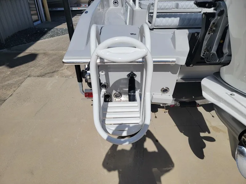Slide: The Image of 2025 Shallow Sport 24 Modified V boat with rear ladder and deck details. - 14