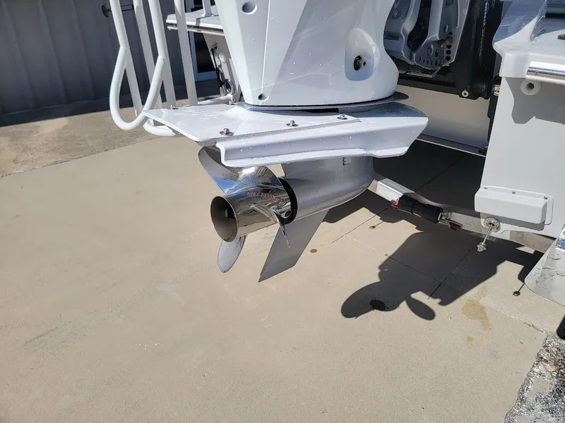 Slide: The Image of 2025 Shallow Sport 24 Modified V boat propeller detail on concrete surface. - 16