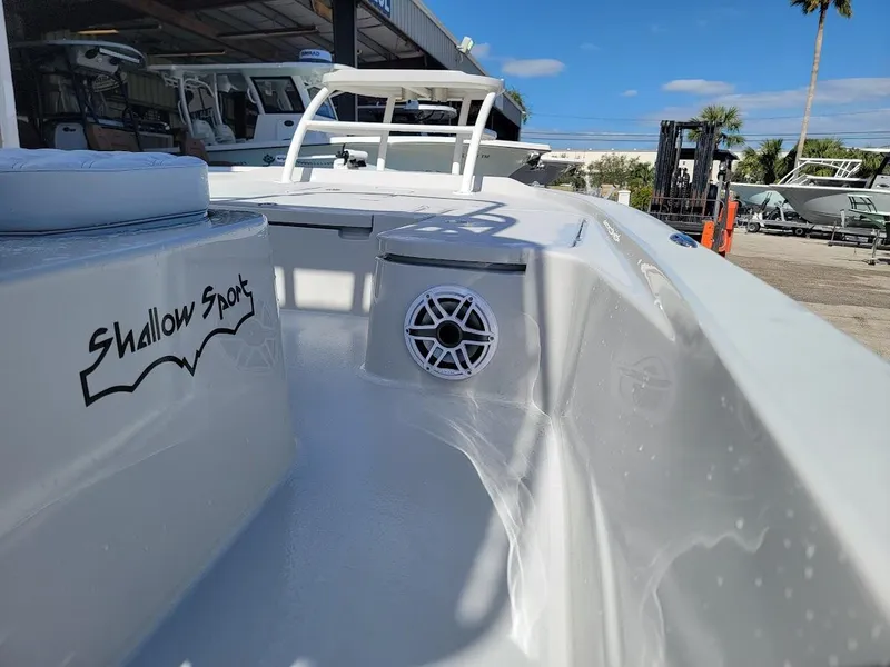 Slide: The Image of 2025 Shallow Sport 24 Modified V boat, sleek design, outdoor setting, clear sky. - 19
