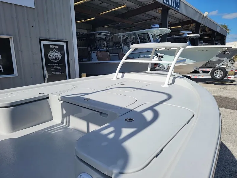 Slide: The Image of 2025 Shallow Sport 24 Modified V boat displayed at a dealership. - 20