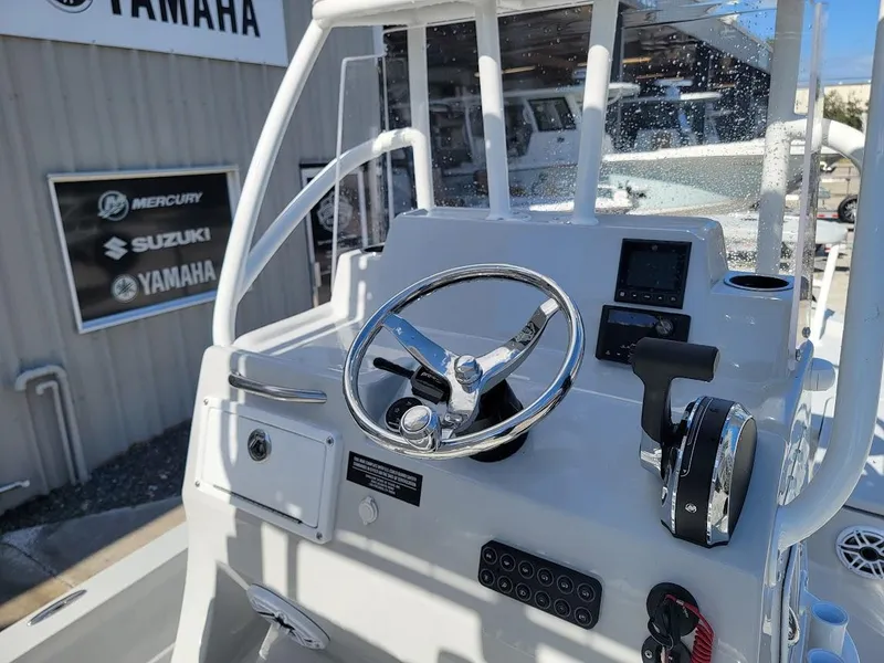 Slide: The Image of 2025 Shallow Sport 24 Modified V boat console with steering wheel and controls. - 21
