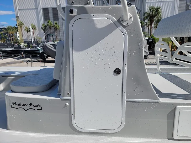 Slide: The Image of 2025 Shallow Sport 24 Modified V boat with sleek design and storage compartment. - 24