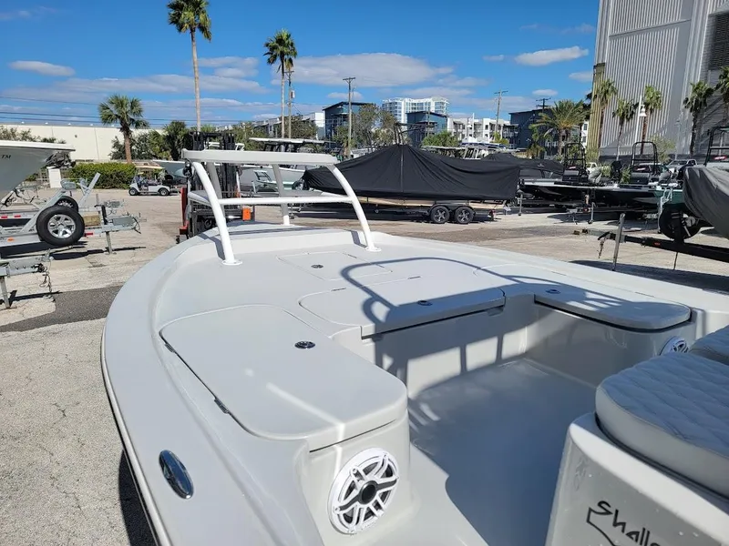 Slide: The Image of 2025 Shallow Sport 24 Modified V boat in marina, clear sky, palm trees. - 28