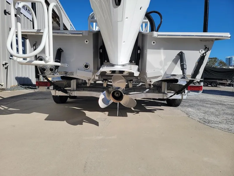 Slide: The Image of Rear view of 2025 Shallow Sport 24 Modified V boat with visible propeller and trailer. - 4