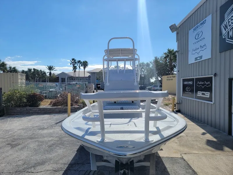 Slide: The Image of 2025 Shallow Sport 24 Modified V boat displayed outdoors near dealership. - 8