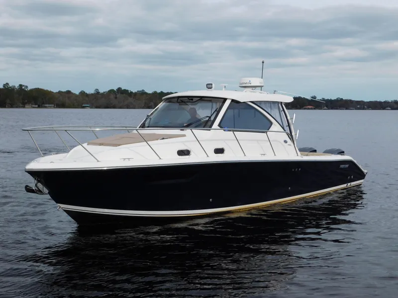 Slide: The Image of 2018 Pursuit OS 325 Offshore boat on calm water, side view. - 0