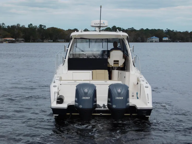 Slide: The Image of 2018 Pursuit OS 325 Offshore boat with dual 300 horsepower engines on a calm lake. - 11