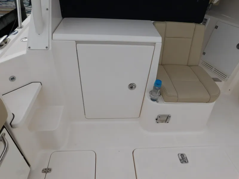 Slide: The Image of 2018 Pursuit OS 325 Offshore boat interior with seating and storage compartment. - 13