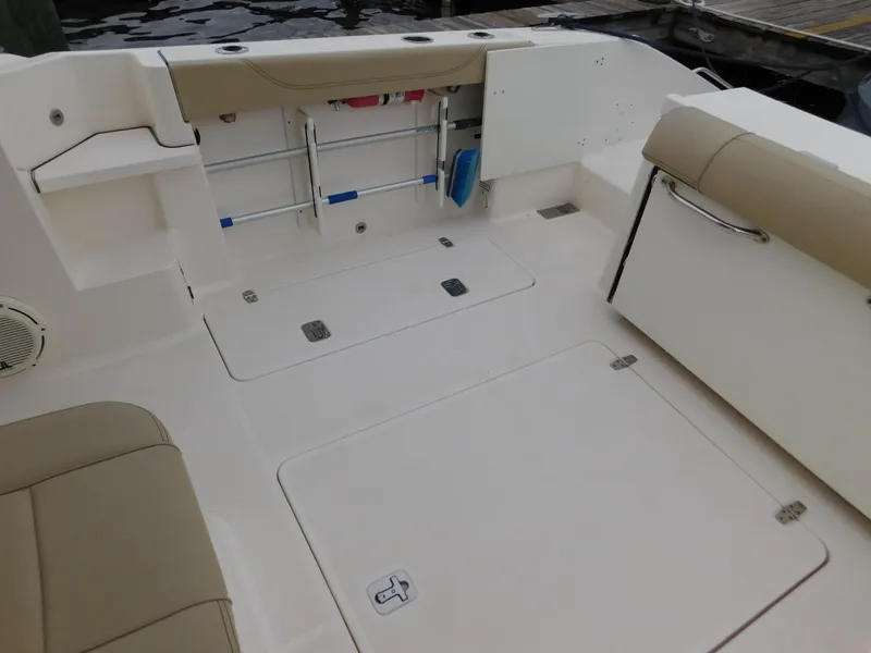 Slide: The Image of 2018 Pursuit OS 325 Offshore boat deck with storage compartments and seating. - 15