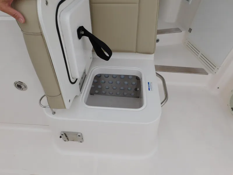 Slide: The Image of 2018 Pursuit OS 325 Offshore boat seat with storage compartment open. - 19