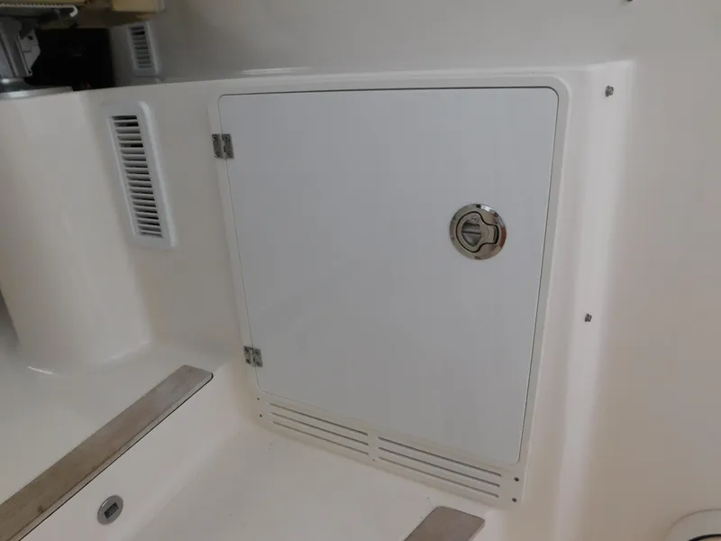 Slide: The Image of 2018 Pursuit OS 325 Offshore boat storage compartment with secure latch. - 21