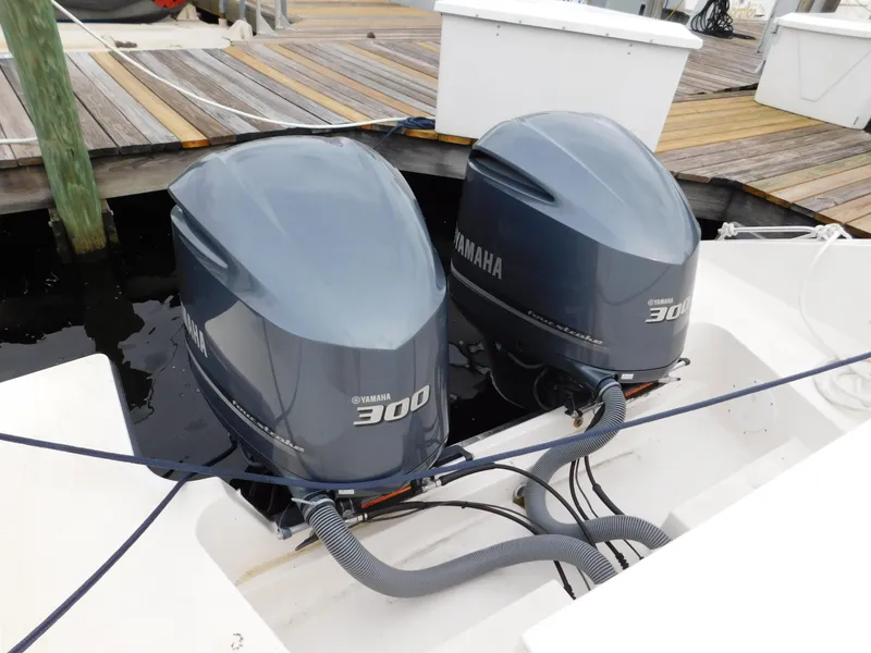 Slide: The Image of Twin Yamaha 300 engines on a 2018 Pursuit OS 325 Offshore boat at dock. - 24