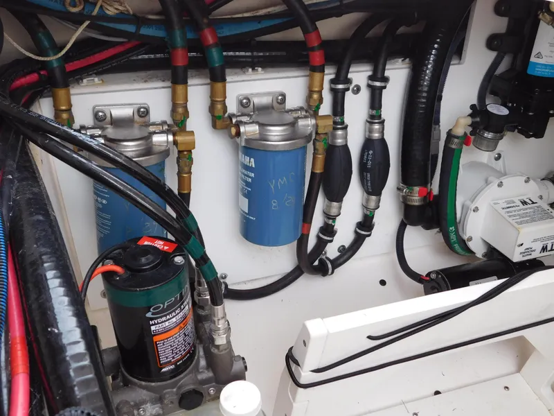 Slide: The Image of Engine compartment of a 2018 Pursuit OS 325 Offshore boat, showing filters and wiring. - 31