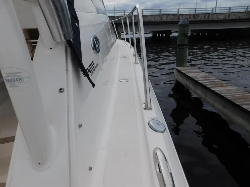 Slide: The Image of 2018 Pursuit OS 325 Offshore boat docked by the water. - 33
