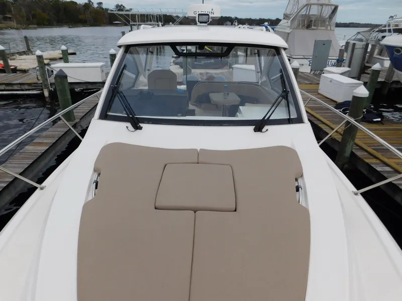 Slide: The Image of 2018 Pursuit OS 325 Offshore boat docked, featuring spacious deck and sleek design. - 36