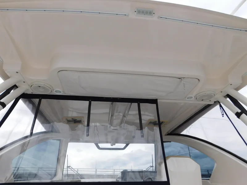 Slide: The Image of 2018 Pursuit OS 325 Offshore boat interior with clear canopy and modern design. - 43