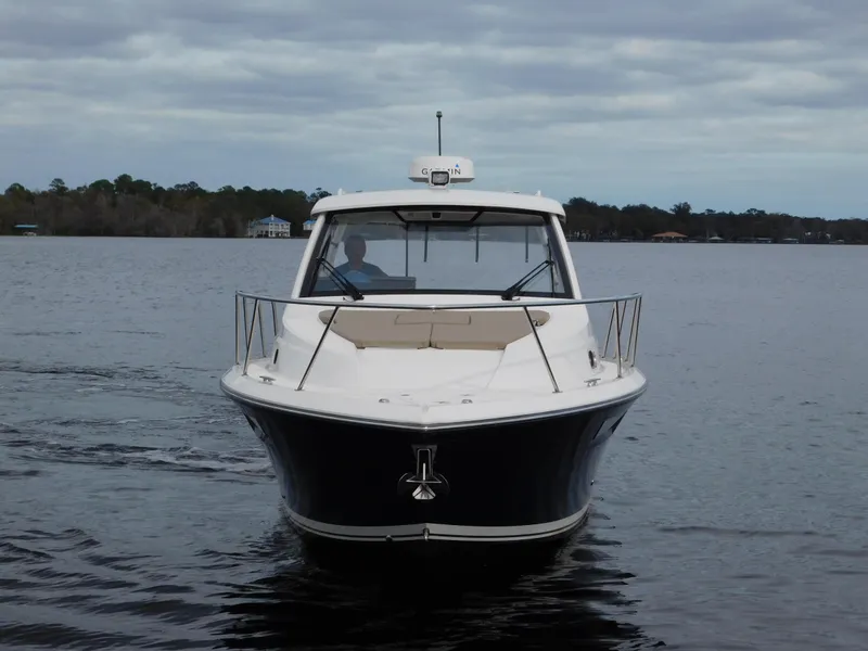 Slide: The Image of 2018 Pursuit OS 325 Offshore boat on calm water under cloudy sky. - 5