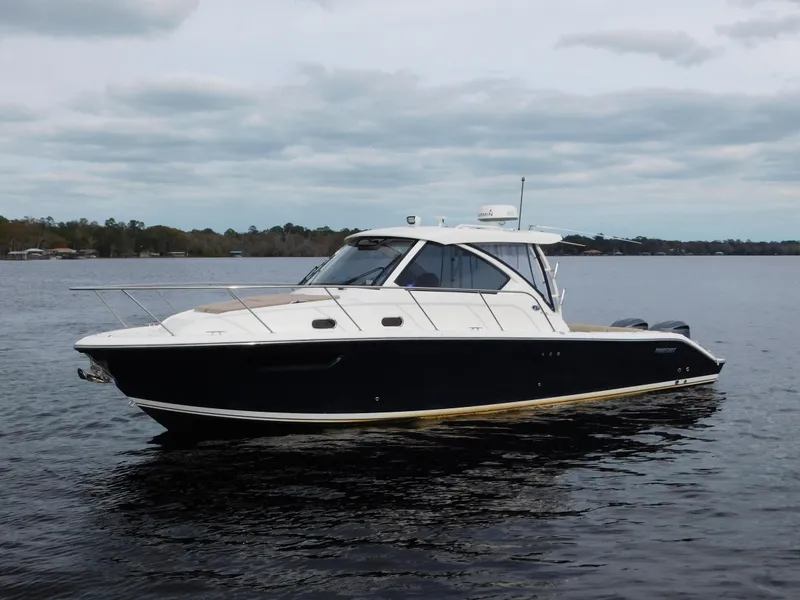 Slide: The Image of 2018 Pursuit OS 325 Offshore boat on calm water under cloudy sky. - 7