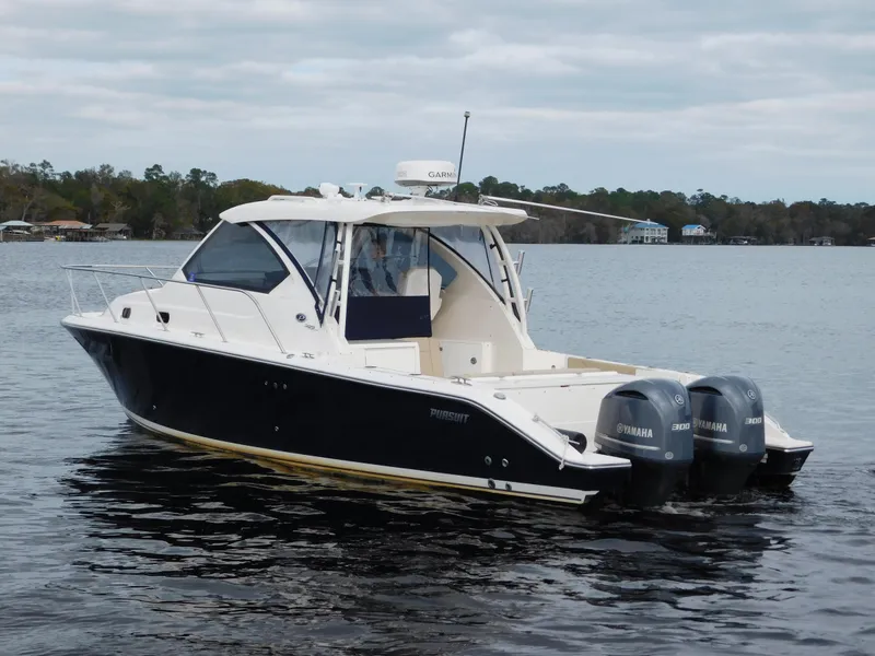 Slide: The Image of 2018 Pursuit OS 325 Offshore boat with twin Yamaha engines on a calm lake. - 9