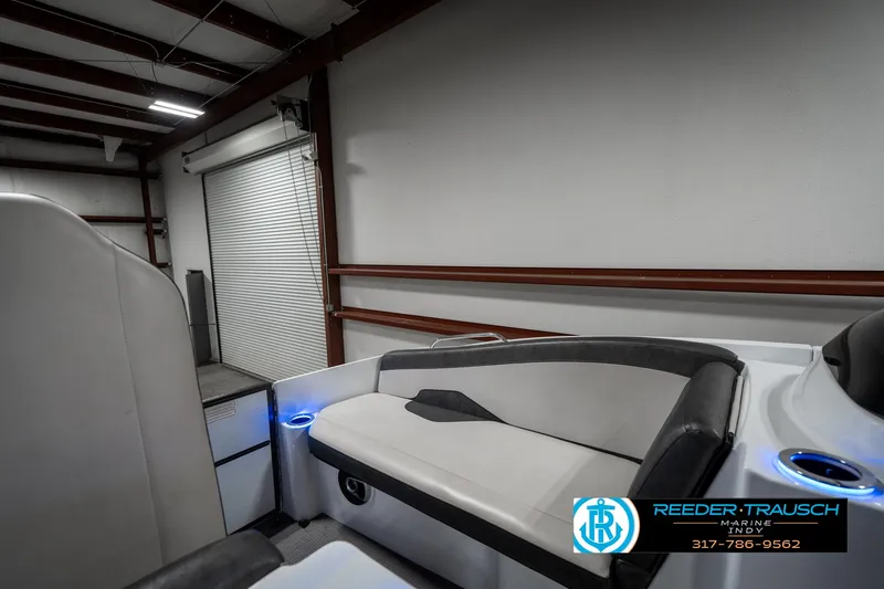 Slide: The Image of 2019 Crest Calypso 190 boat interior with modern seating in a storage facility. - 19