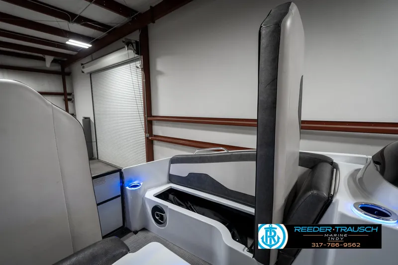 Slide: The Image of 2019 Crest Calypso 190 boat interior with storage compartment in a warehouse setting. - 20