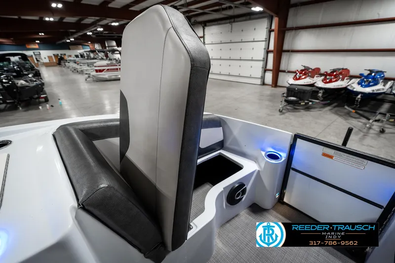 Slide: The Image of 2019 Crest Calypso 190 boat interior with seating and storage in a showroom. - 22